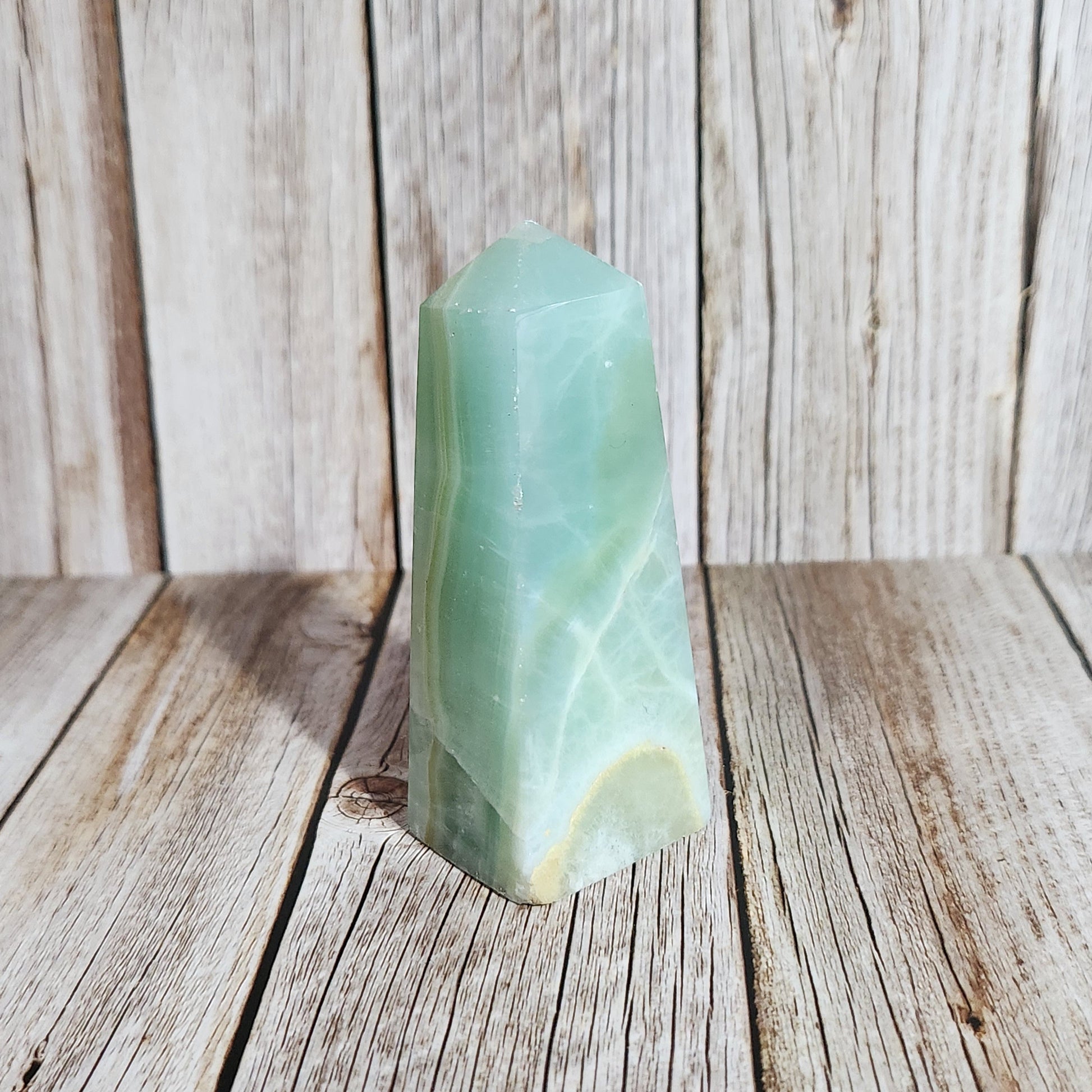 Green stone on a wooden surface