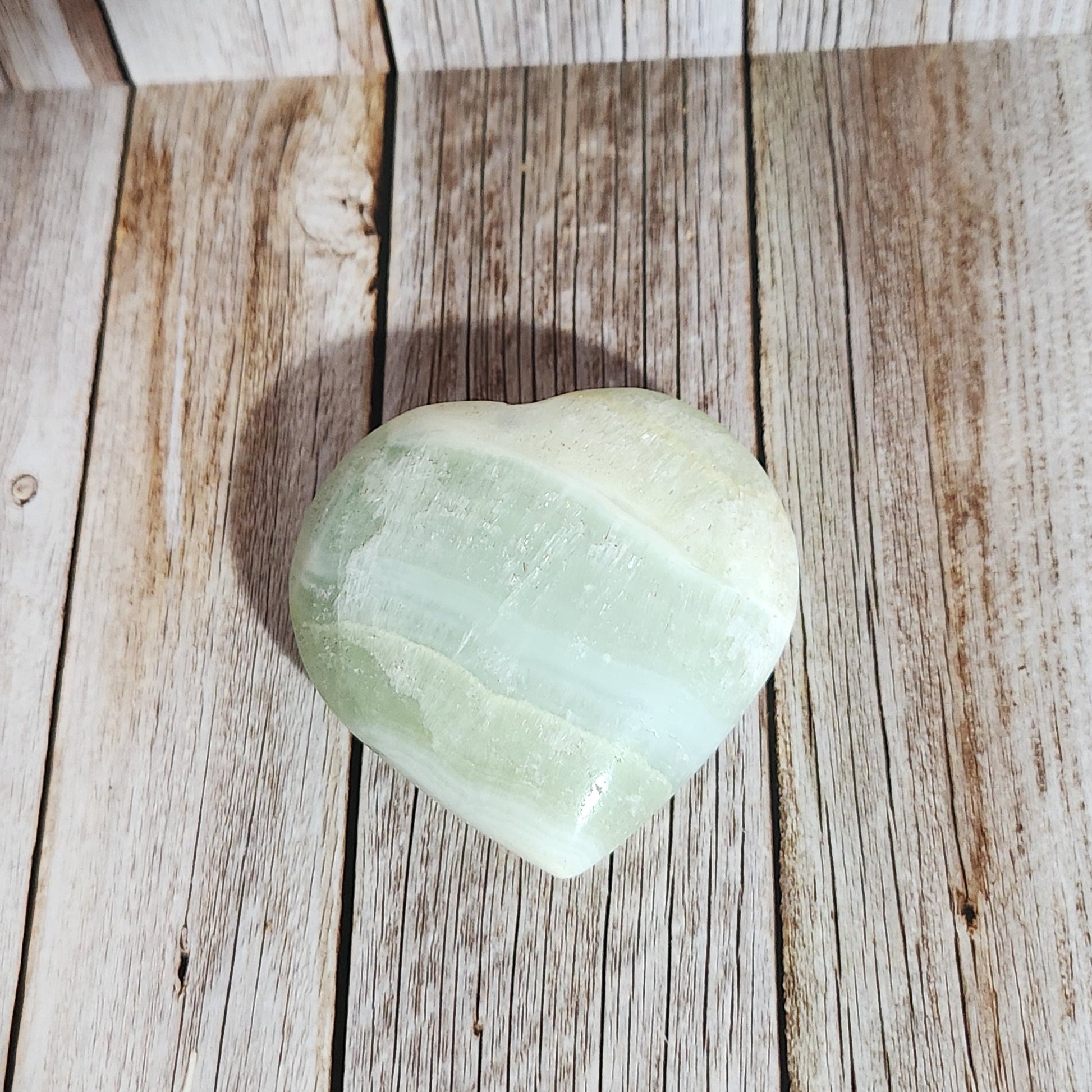 Green crystal on a wooden surface