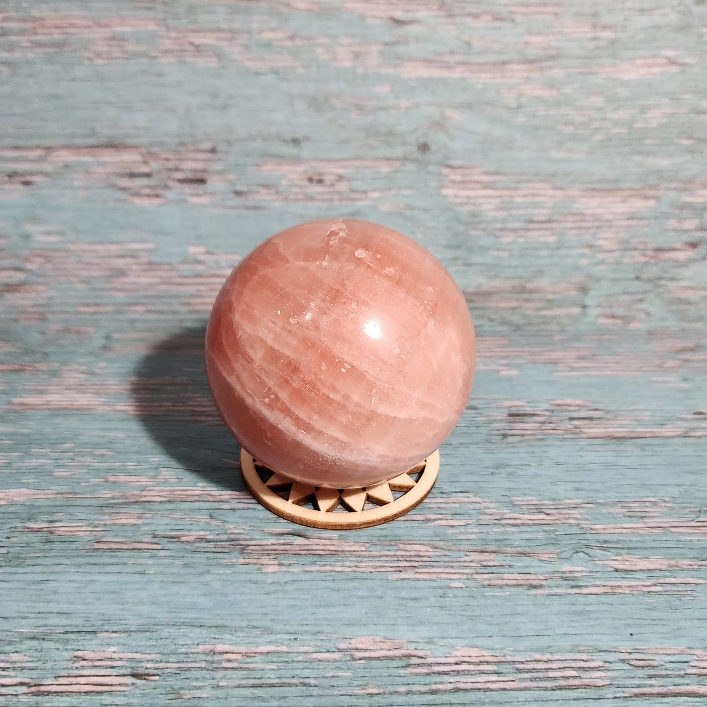 Pink door knob on a textured blue door