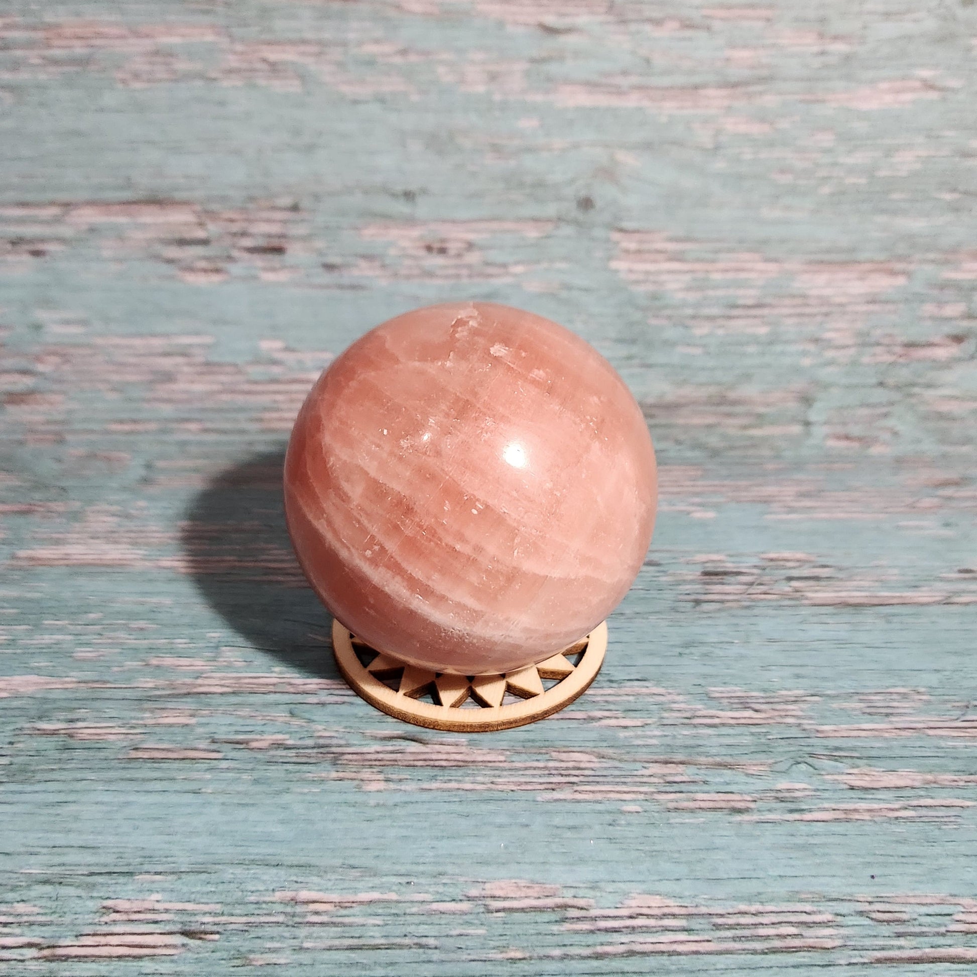 Pink door knob on a textured blue door