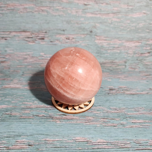 Pink door knob on a textured blue door