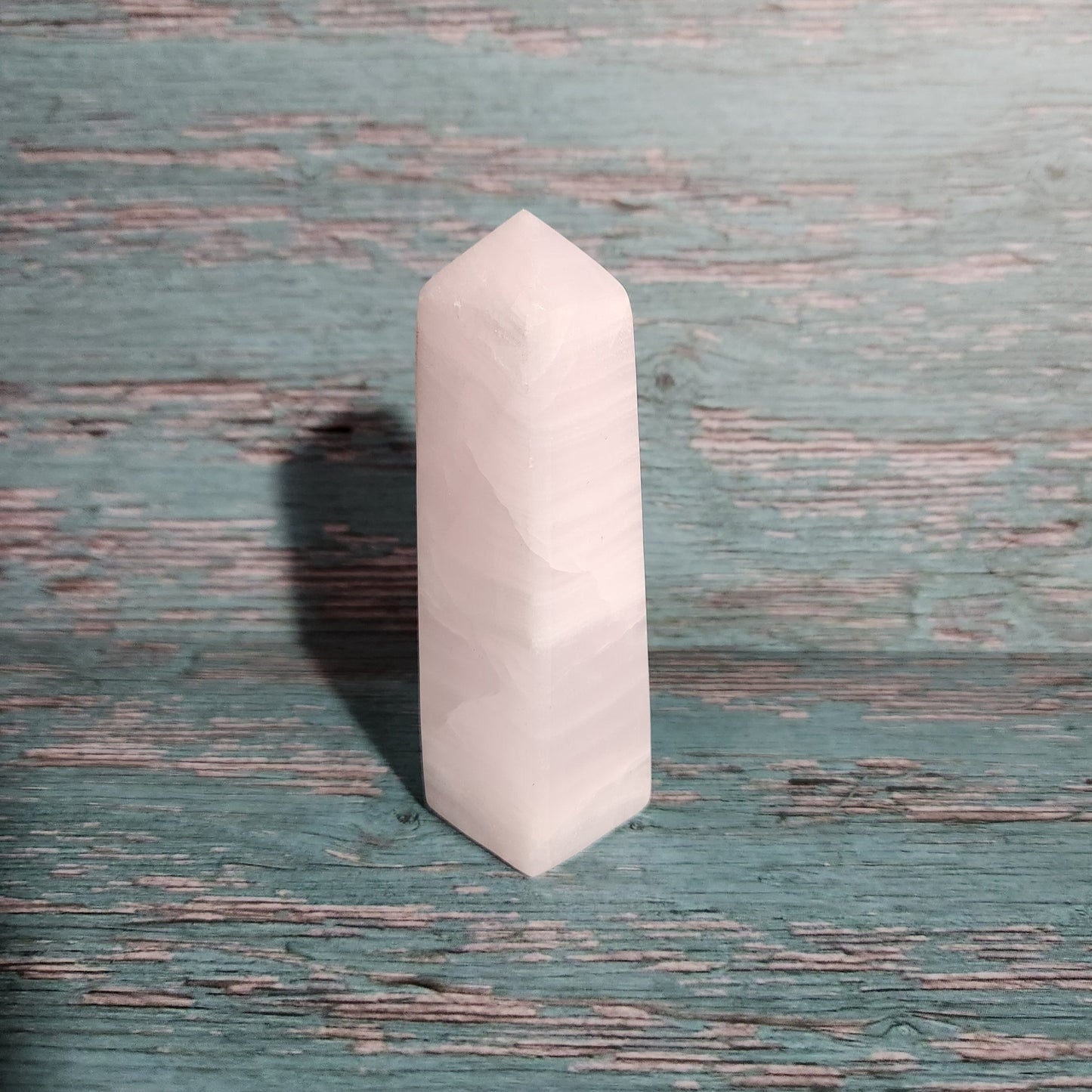 White hexagonal stone on a textured green surface