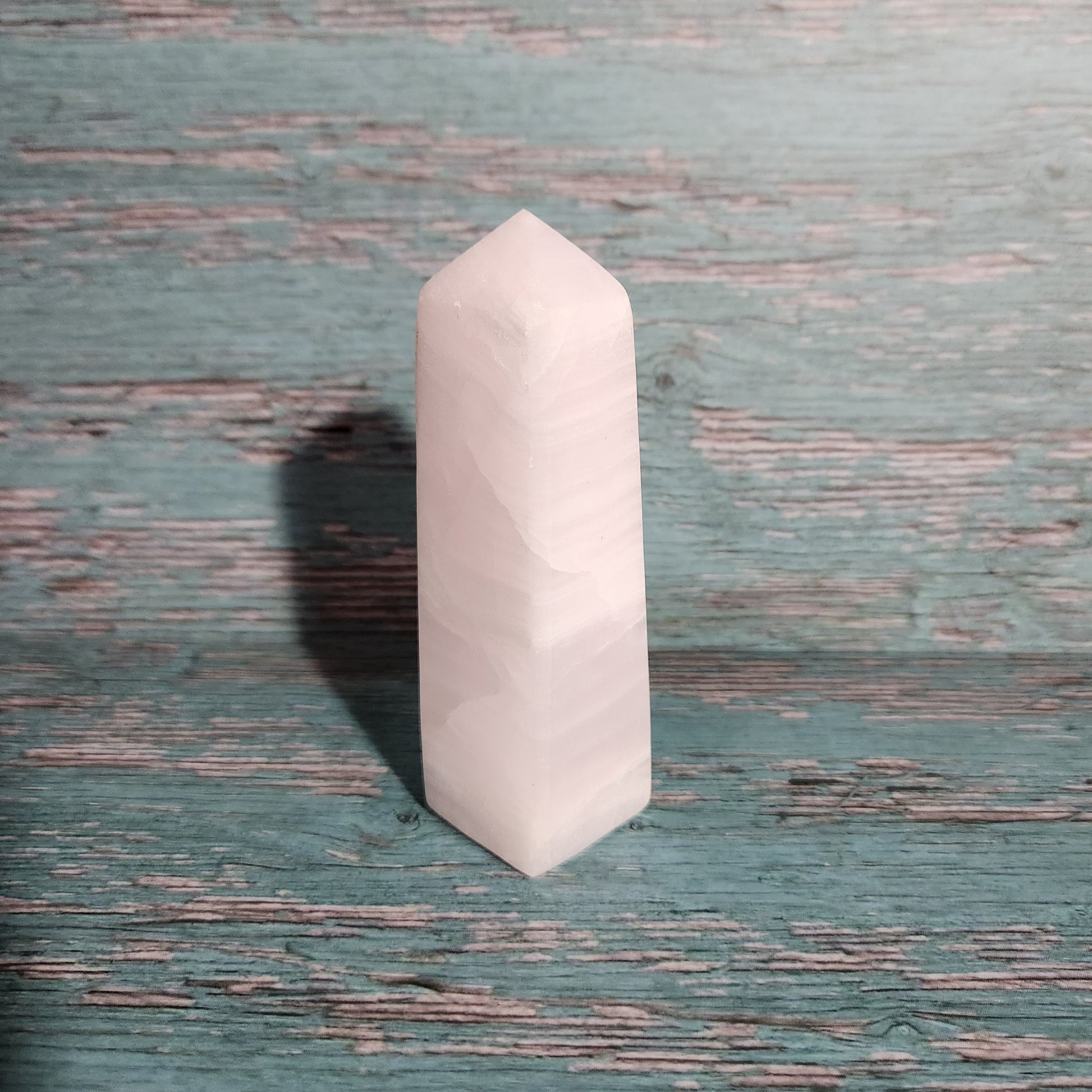White hexagonal stone on a textured green surface