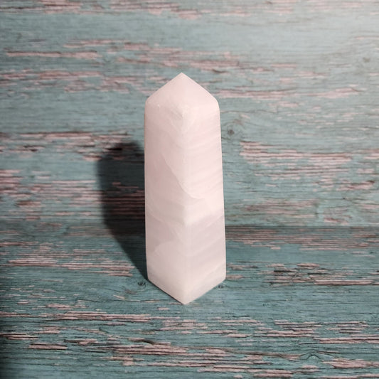 White hexagonal stone on a textured green surface